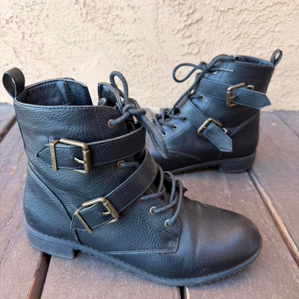 Black combat boots with gold buckles